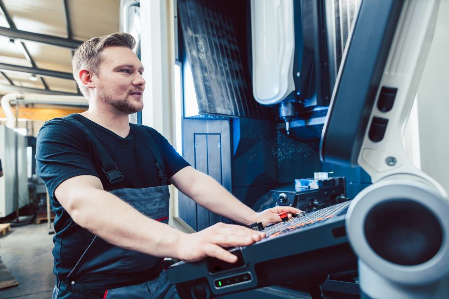 A machinist programs a modern CNC lathe