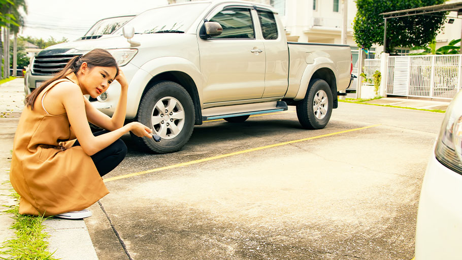 A woman in a parking lot from which her car was stolen.