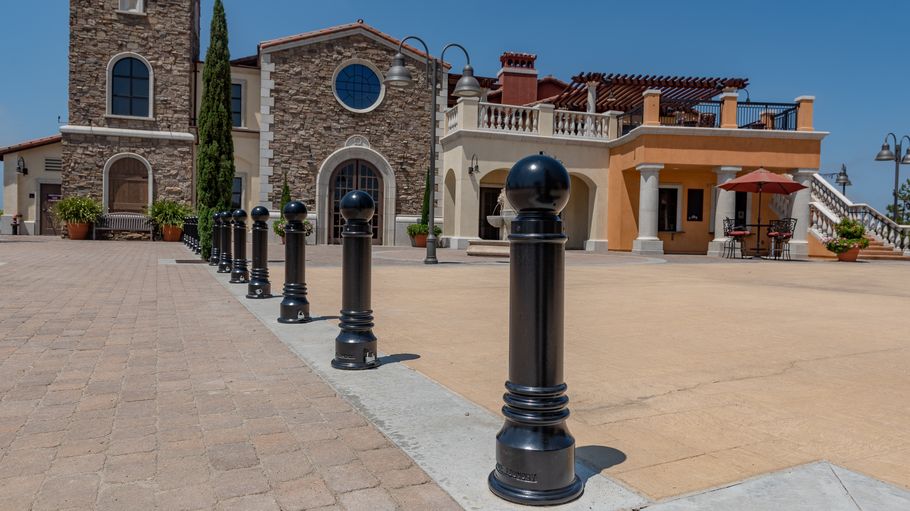 A cobblestone plaza in front of a large church on a sunny day