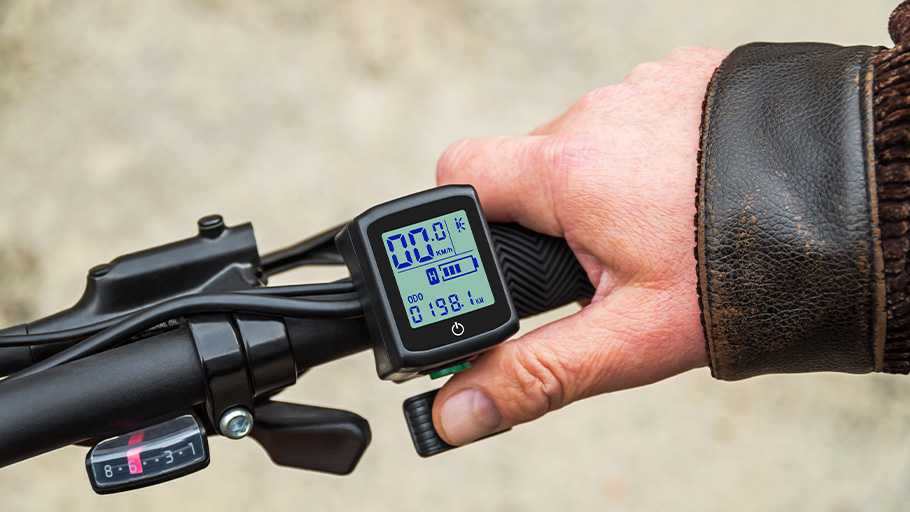 A close-up shot of the display and accelerator on an electric bike.