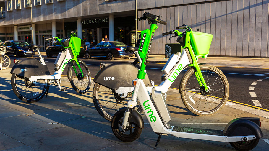 An image of electric bikes and an electric scooter on a London street