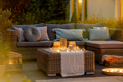 Cushioned patio furniture sits around a modern coffee table.