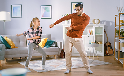 A dad practices a TikTok dance with his daughter.