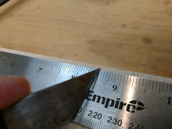 lining up your marking knife on a ruler