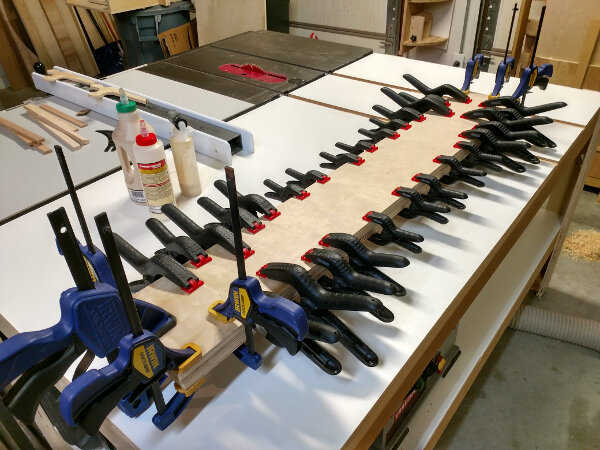 Fence stock being glued and clamped