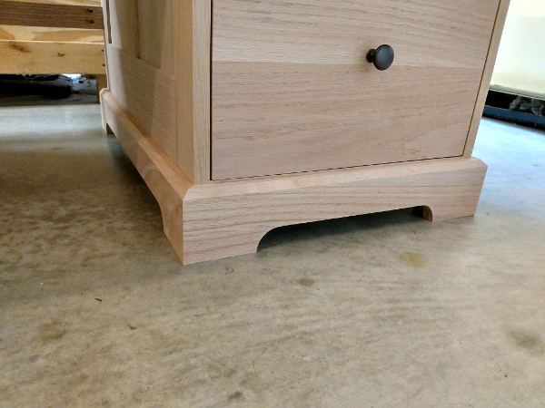 A closeup of the base molding on one side of the desk