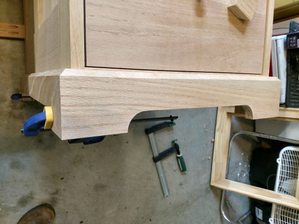 Side finished baseboard clamped on furniture