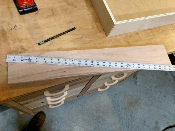 Using a 3 foot rule to mark center point of drawer face