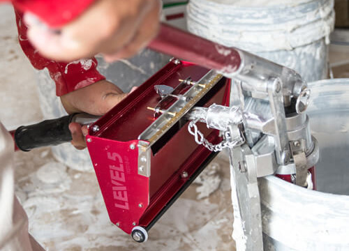 LEVEL5 Drywall Flat Box being filled with joint compound using a LEVEL5 Drywall Compound Pump and Box Filler Valve.