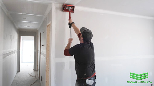 Drywall nation showing how to use a drywall flat box on vertical wall joints.