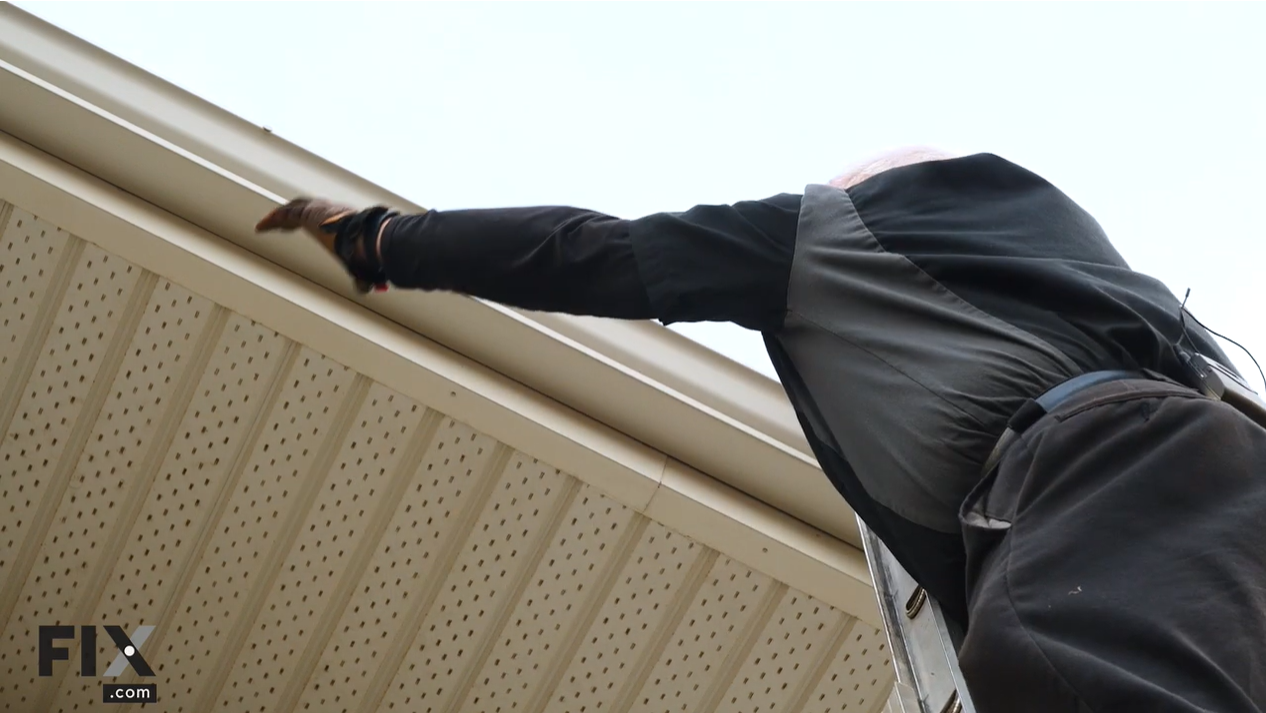 Person Reaching Over on a Ladder